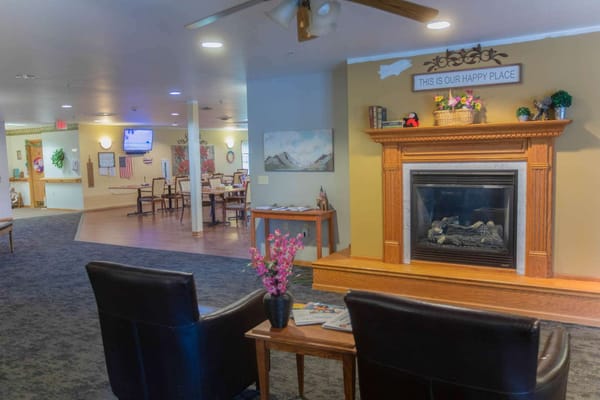 Bright common area with seating and fireplace