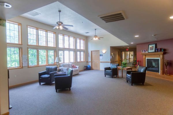 Bright common area with seating and large windows