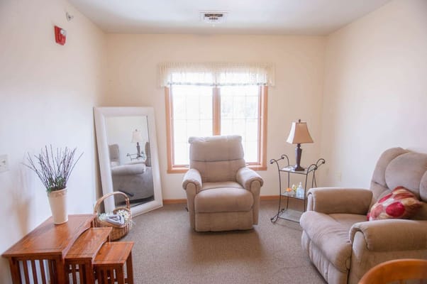 Cozy resident room with seating and natural light