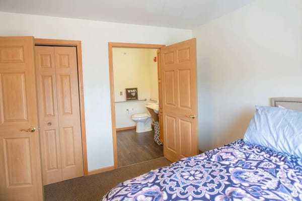 Private resident room with bathroom entrance visible