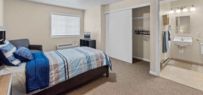 A private resident room with a bed and bathroom