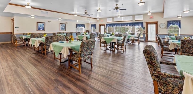 Bright dining room with tables set for meals