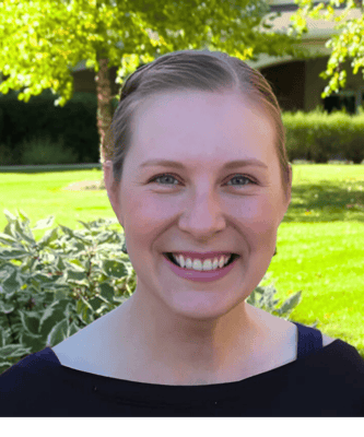 Staff member smiling in an outdoor garden area