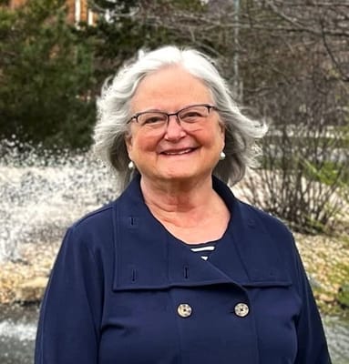 Smiling resident outdoors near a fountain