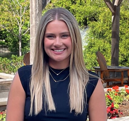 A smiling woman in a garden setting