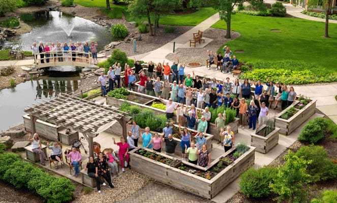 Residents and staff celebrating in a garden area