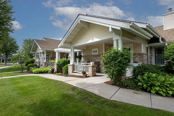 Exterior view of assisted living facility with garden