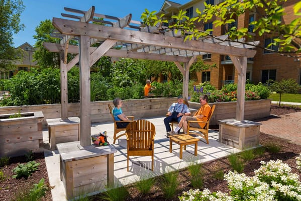 Residents enjoying time in a garden seating area