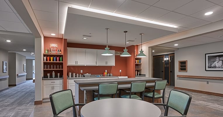 Bright interior common area with bar seating and decorative wall