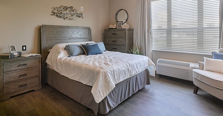 A cozy resident room with a bed and furnishings