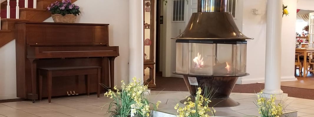 Interior view of a warm common area with a fireplace