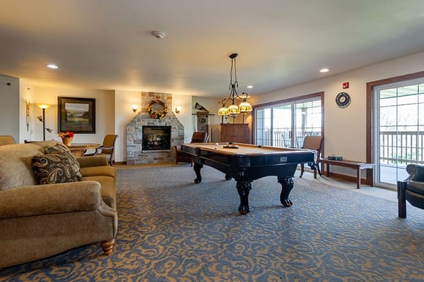 Common area with a fireplace and pool table