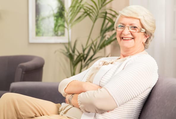 Smiling senior woman seated in a common area
