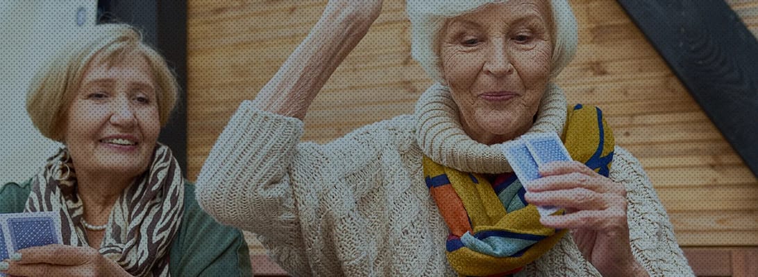 Seniors enjoying a card game in an indoor activity space