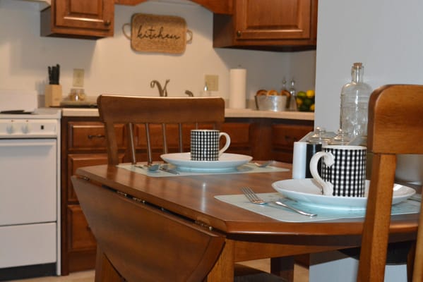 Cozy dining area with kitchen in the background