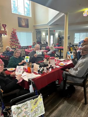 Residents engaged in an art activity in a bright common area
