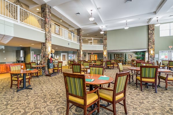Bright common area with dining tables and chairs