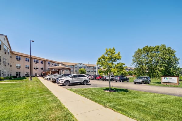 Exterior view of Dimensions Living Stevens Point with cars parked