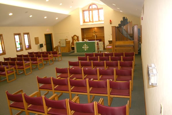 Interior of a serene chapel with rows of chairs