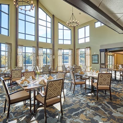 Bright dining room with large windows and elegant seating