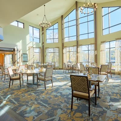 Bright dining room with tables set for meals