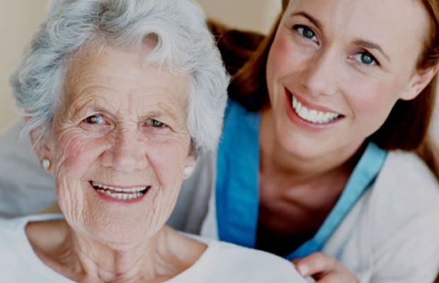 Smiling caregiver with an elderly resident