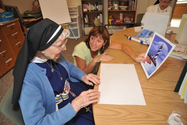 A resident and staff member engaged in an activity