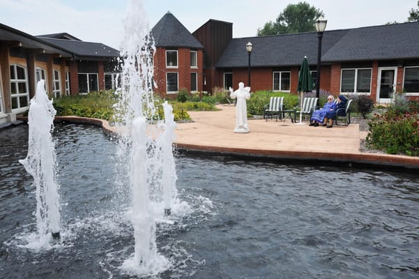 Residents enjoying the outdoor space with a water fountain