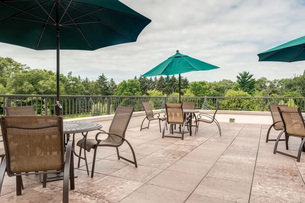 Outdoor seating area with umbrellas and greenery