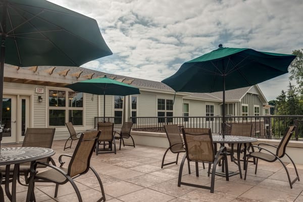 Outdoor patio area with tables and umbrellas