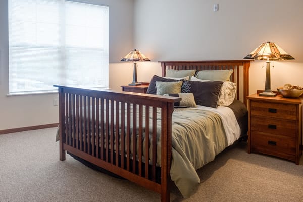 A well-furnished private resident room with soft lighting