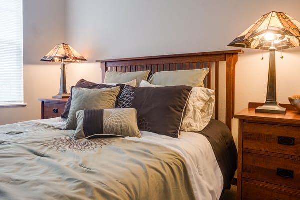 Cozy bedroom with decorative lamps and bedding