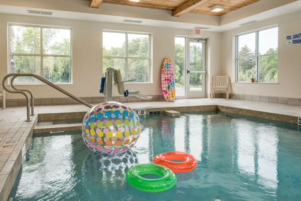 Indoor pool area with colorful floats and balls
