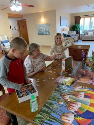Residents enjoying a puzzle activity at a table