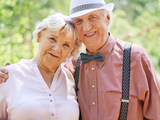 Happy senior couple posing outdoors in the garden