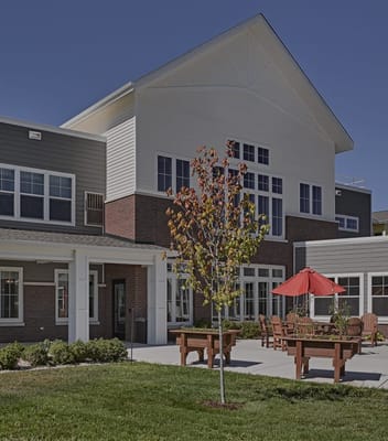 Exterior view of Kettle Park Senior Living building with outdoor seating