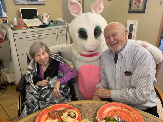 Residents enjoying a meal with a costumed character