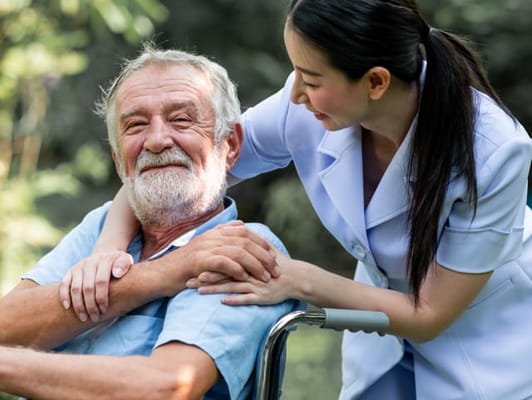A caregiver and resident enjoying time outdoors