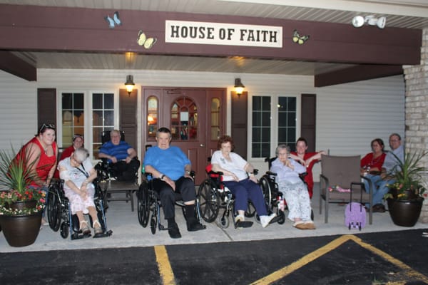 Residents and staff gathered outside the facility entrance