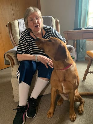 Resident interacting with a dog in a common area