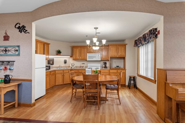 A bright dining room with wooden tables and chairs