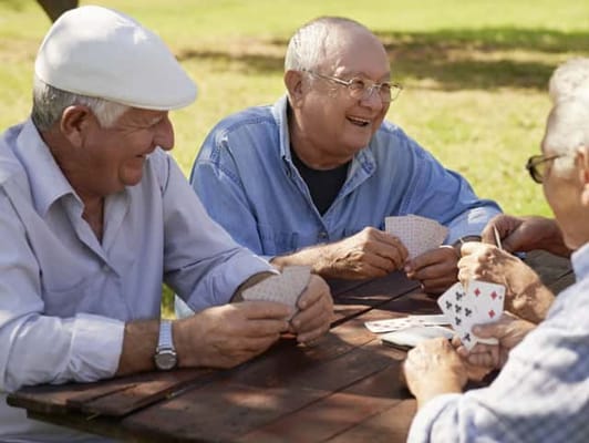 Residents enjoying a game of cards outdoors