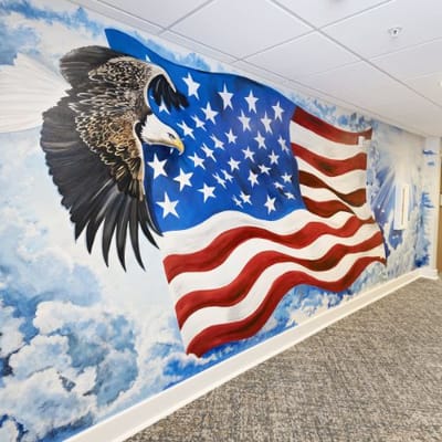 Mural of an eagle and American flag on a wall