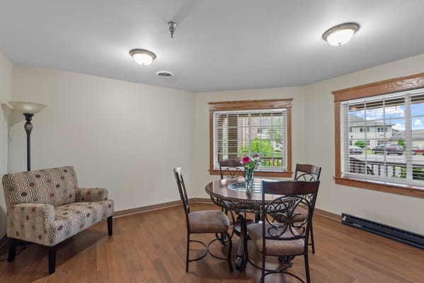 Bright common area with seating and dining table
