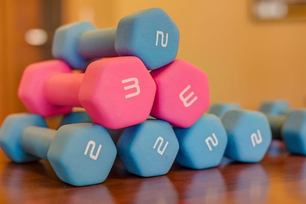 Colorful dumbbells stacked on a table