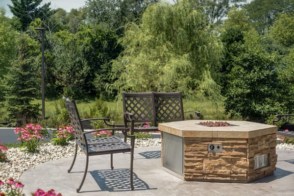 Outdoor seating area with a fire pit and flowers