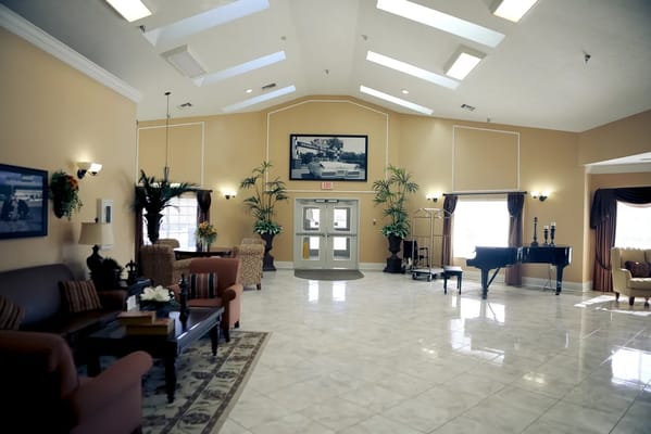 Bright interior lobby with piano and seating area