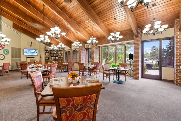 Dining room set up for a meal with flowers
