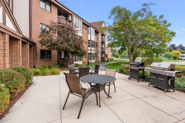 Outdoor seating area with tables and grill