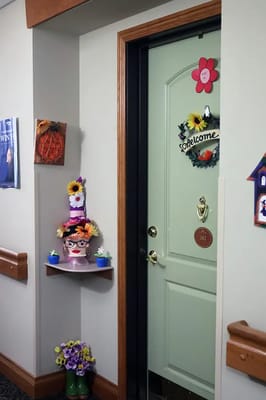 Decorated resident door with welcome signs and flowers